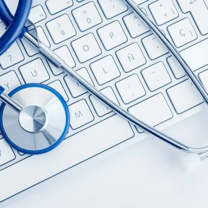 Stethoscope on computer keyboard on white desk